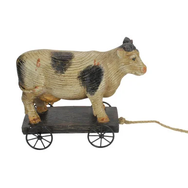 Add Farmhouse Charm with the 10.25″ Black and White Wood Textured Cow on Cart Garden Statue